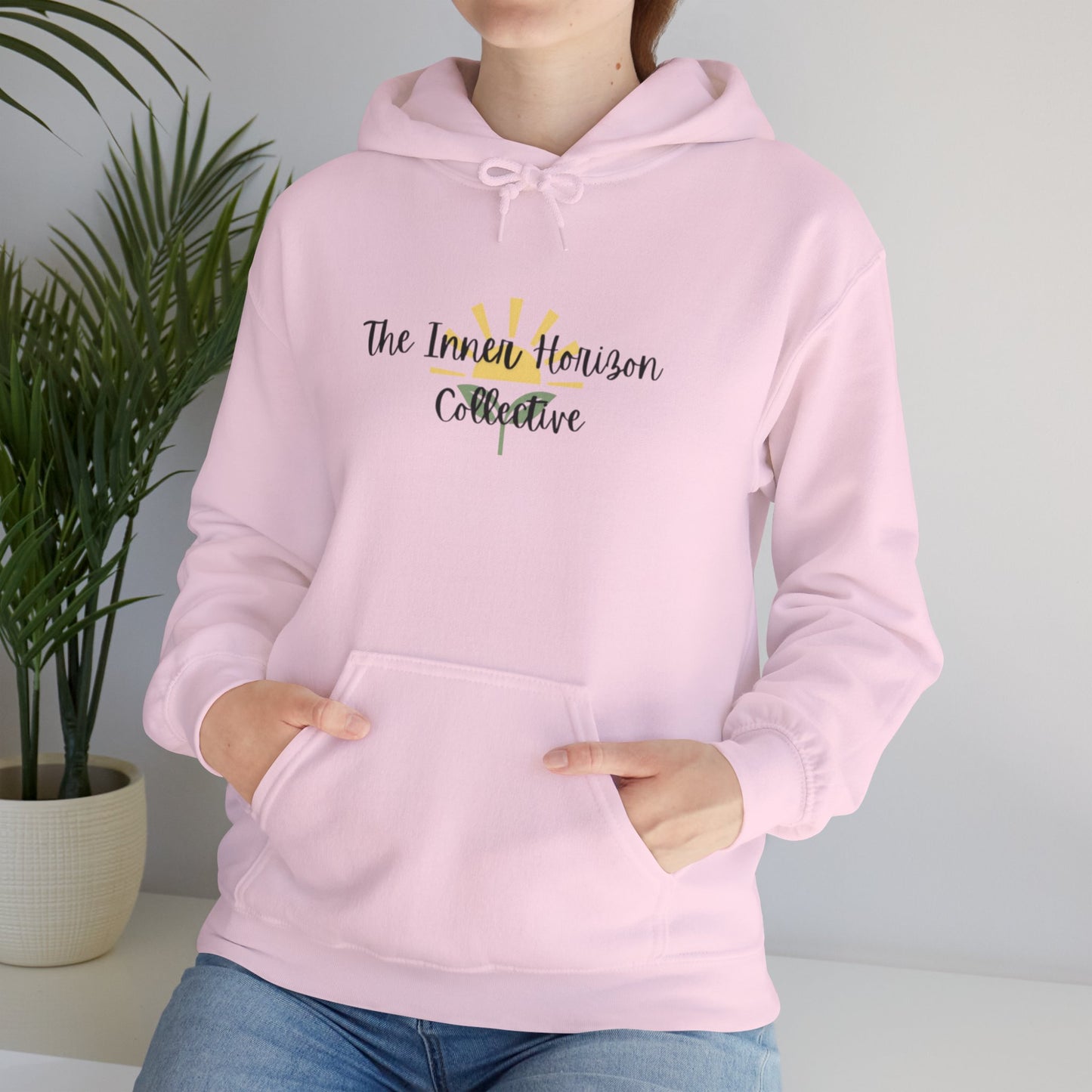 Front view of The Inner Horizon Collective hoodie in Safety Pink with black logo — bold and vibrant casual pullover.