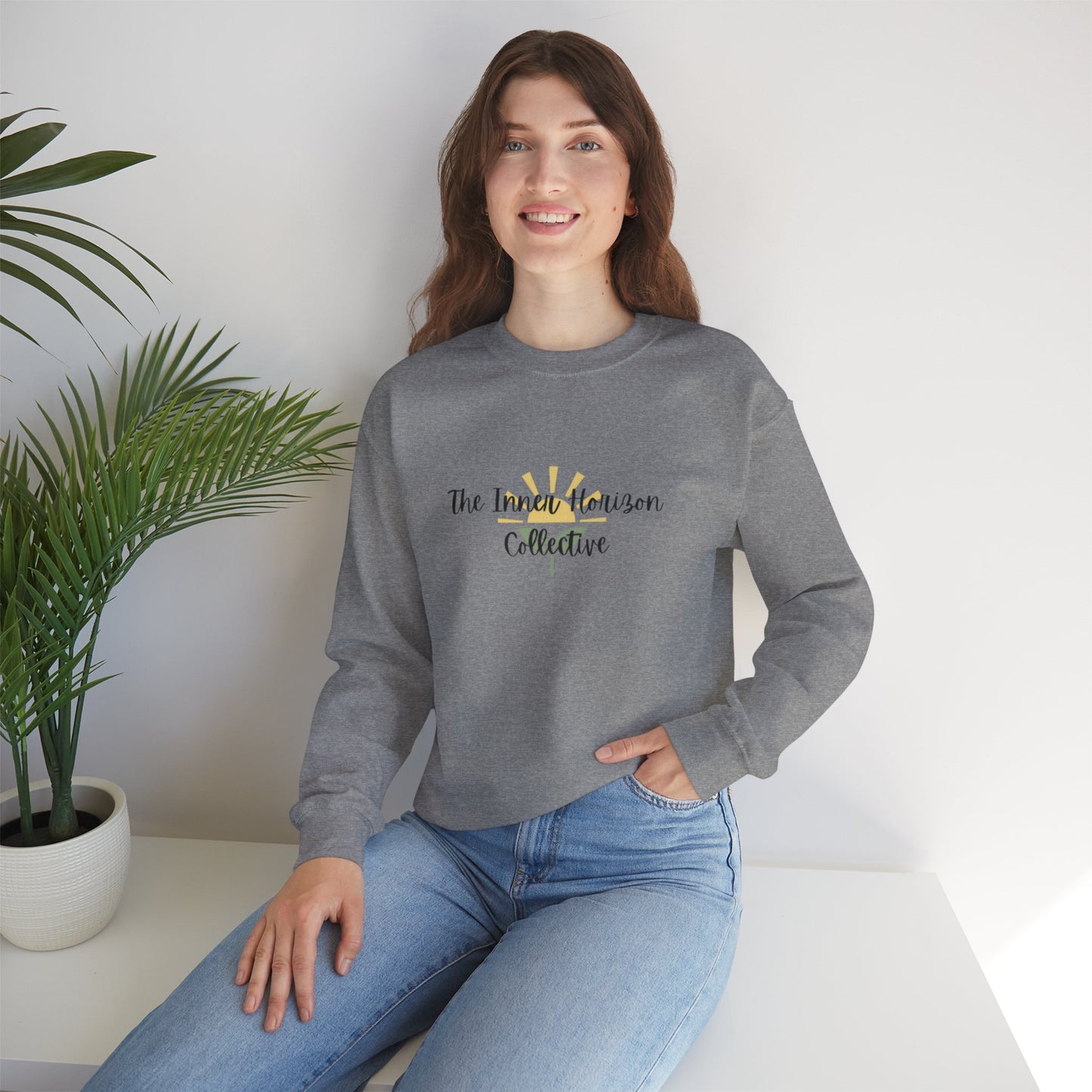 Front view of The Inner Horizon Collective unisex sweatshirt in Graphite Heather with black logo — sleek and modern pullover.