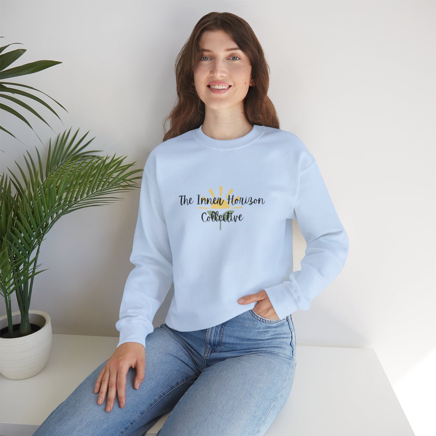 Front view of The Inner Horizon Collective unisex sweatshirt in Light Blue with black logo — comfortable everyday wear.