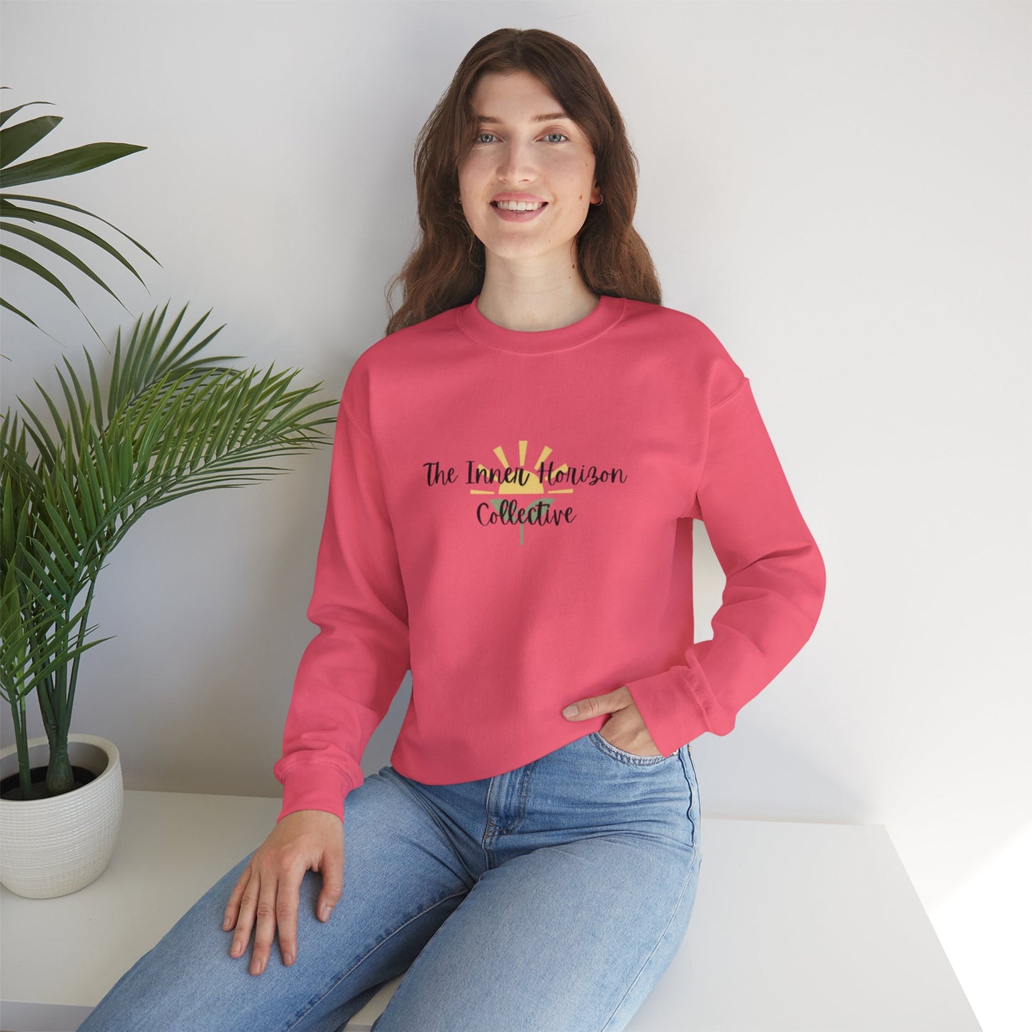 Front view of The Inner Horizon Collective unisex sweatshirt in Safety Pink with black logo — bold and vibrant casual pullover.