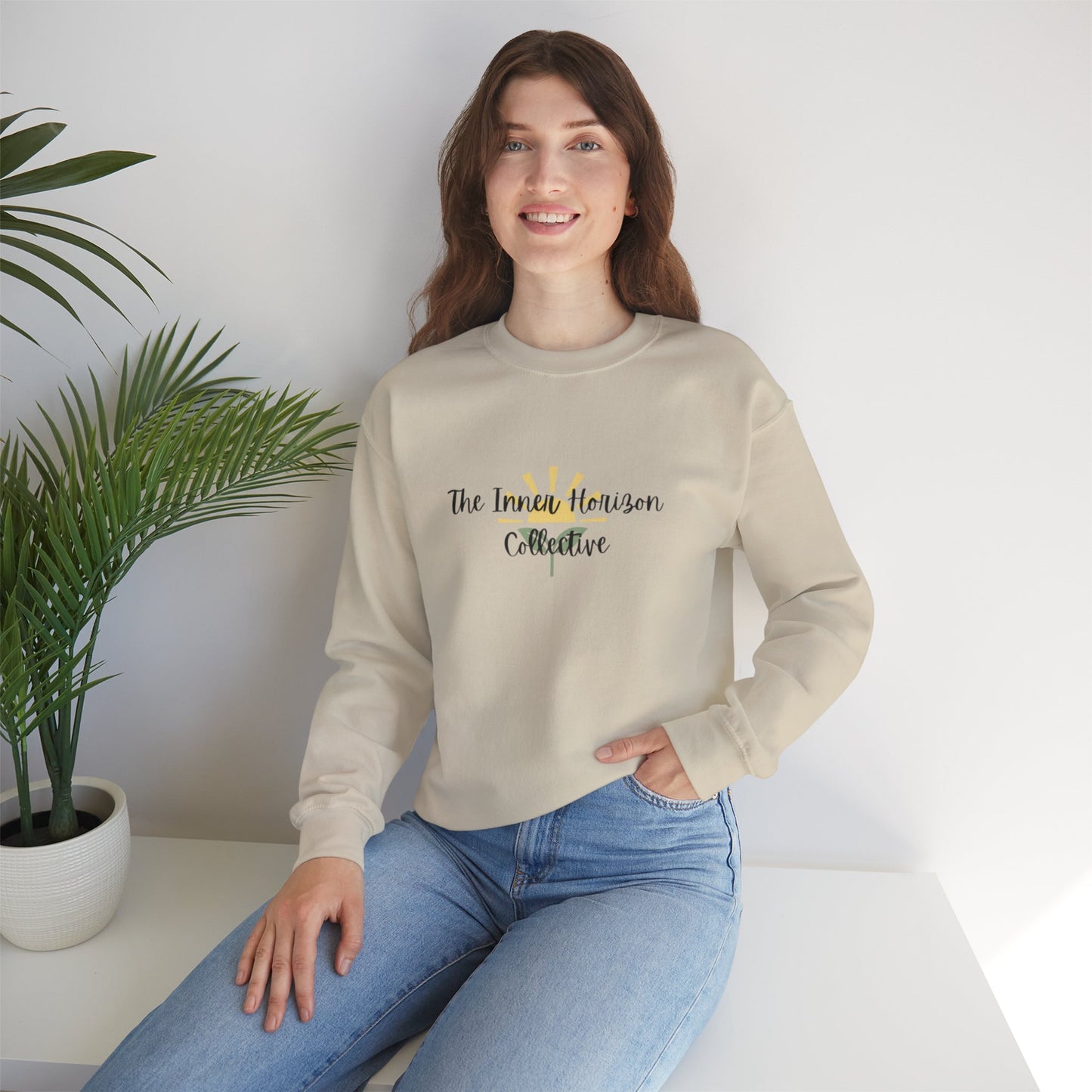 Front view of The Inner Horizon Collective unisex sweatshirt in Sand with black logo — neutral-toned cozy pullover.