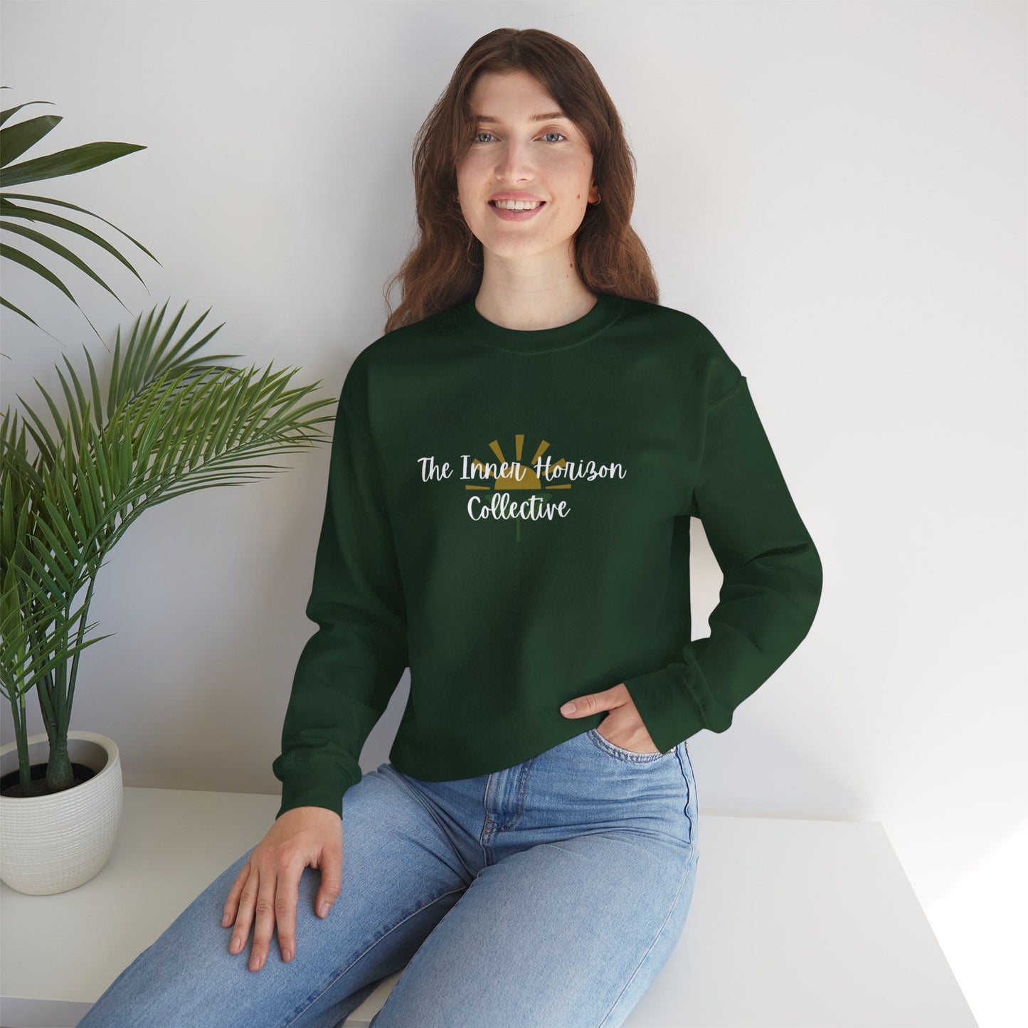 Front view of The Inner Horizon Collective unisex sweatshirt in Forest Green with white logo — earthy-toned casual wear.